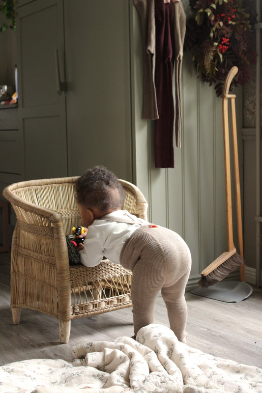 Baby wearing the new Silly Silas retro ribbed baby tights in peanut blend